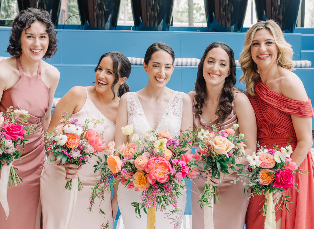 bridesmaids laughing and smiling holding bouquets