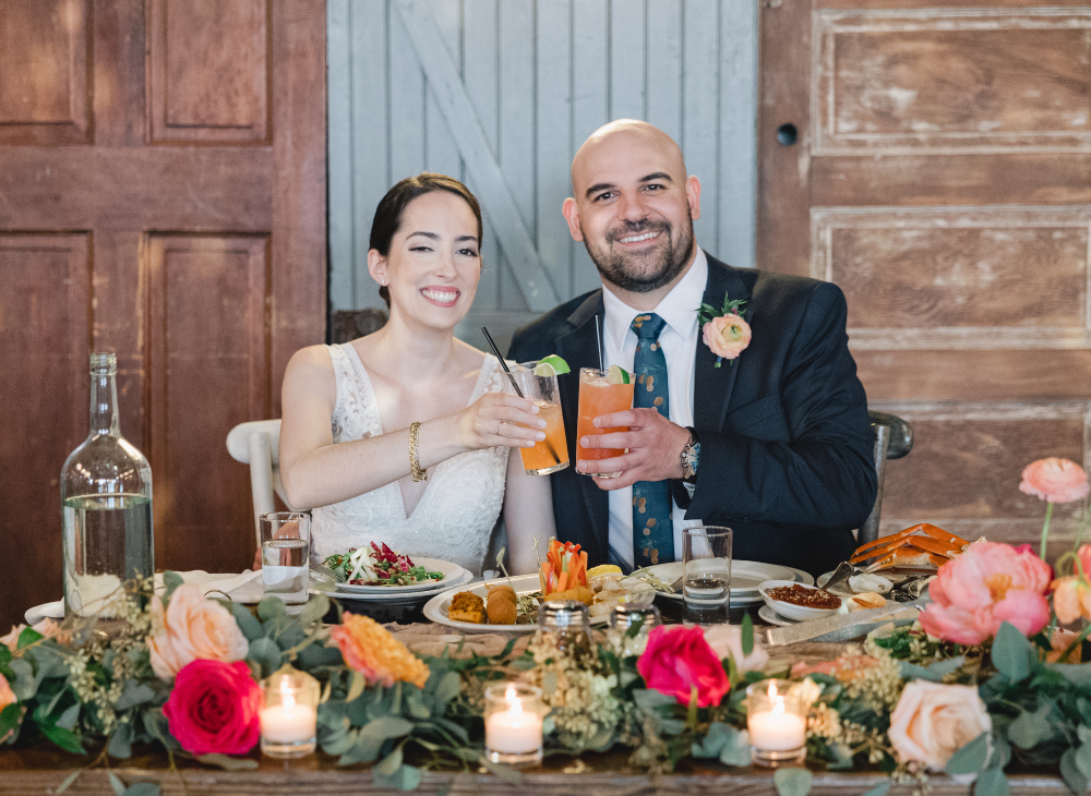 bride and groom toast orange cocktails