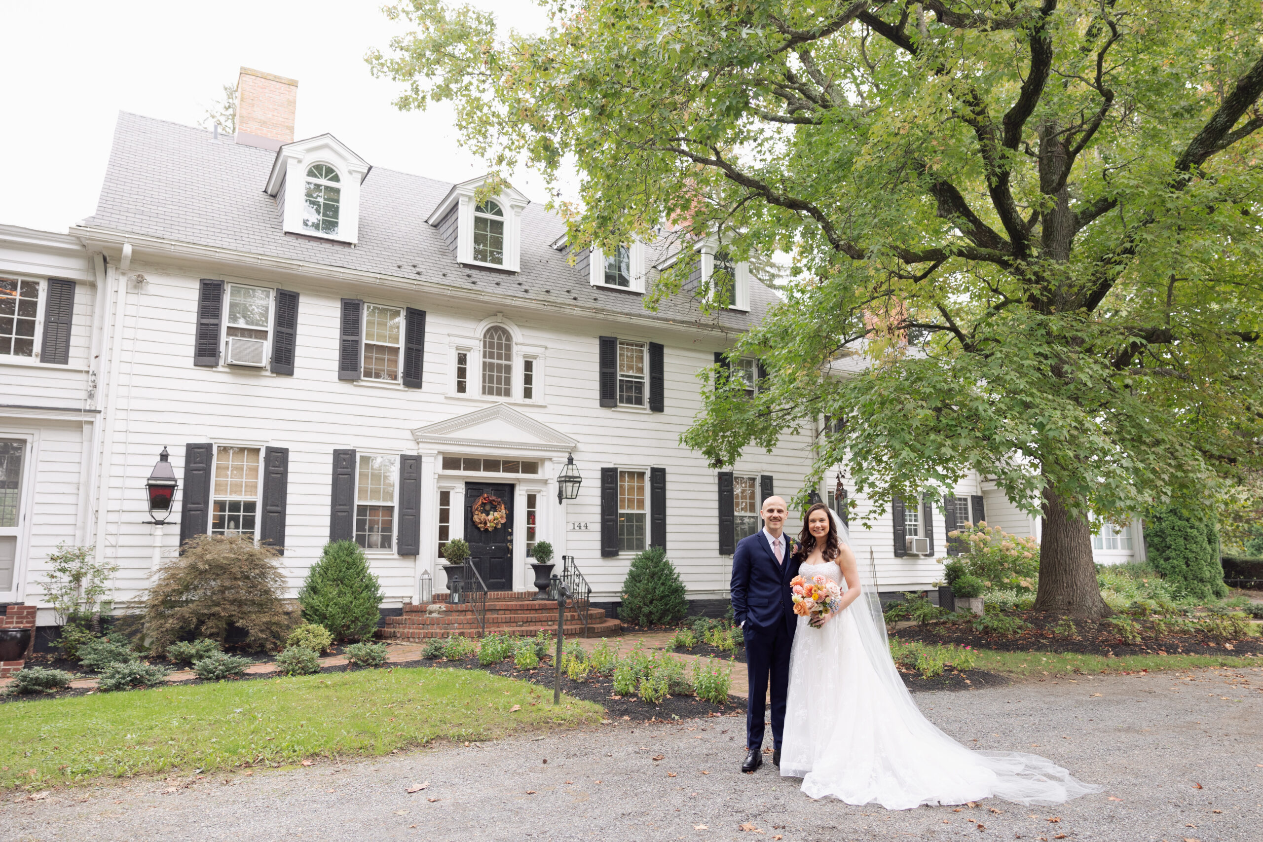 the inn at fernbrook farms married couple standing out front