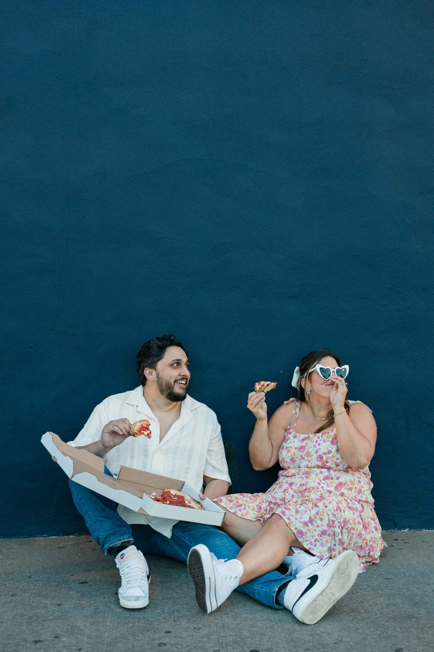 couple with pizza at Porta for engagement photos