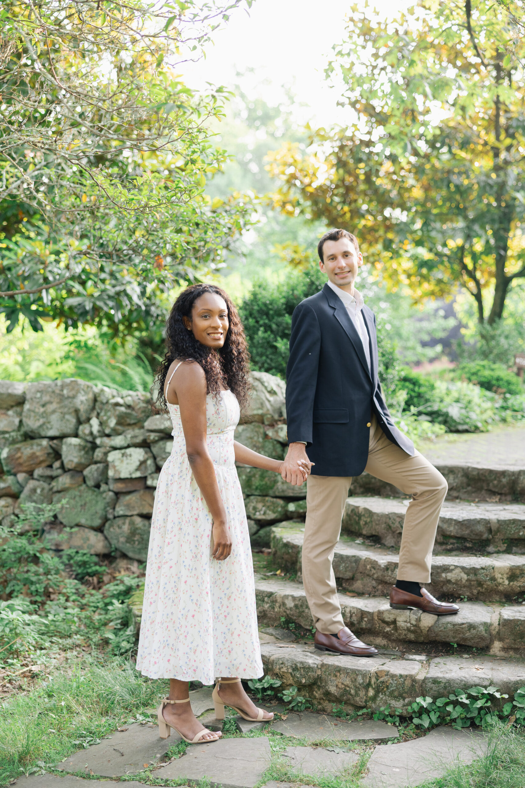 walking up stone steps at cross estate gardens, engagement photographs
