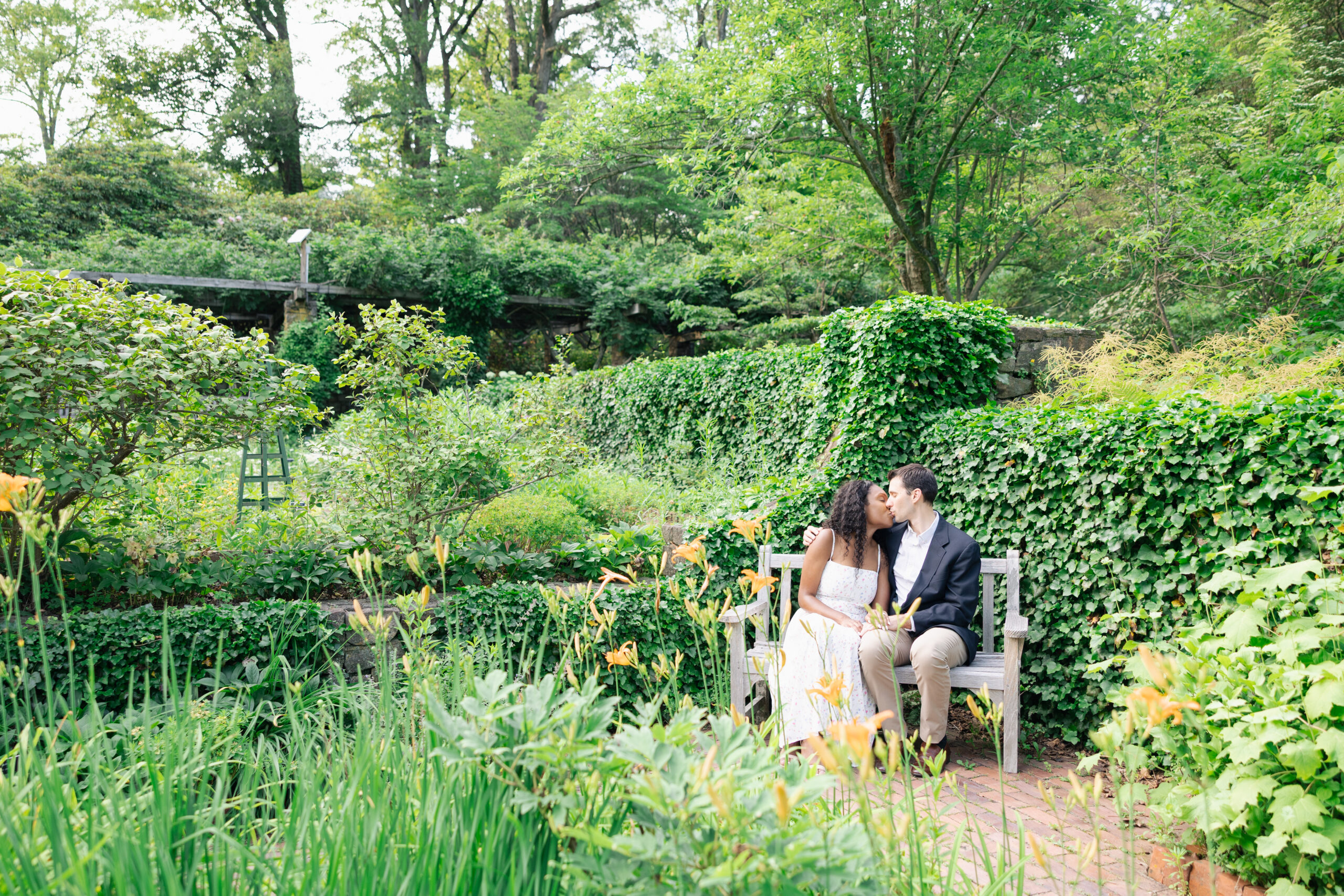 Sitting on a bench at cross estate gardens, engagement photographs