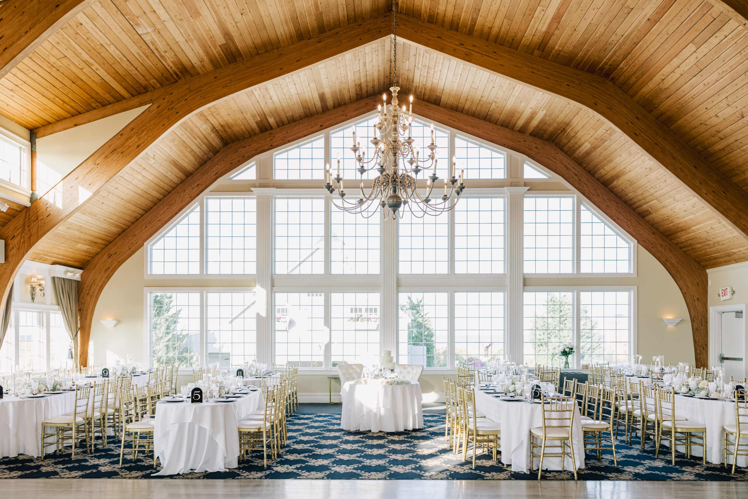 Bonnet Island Estate ballroom with 30-foot ceilings and chandelier set for a wedding reception