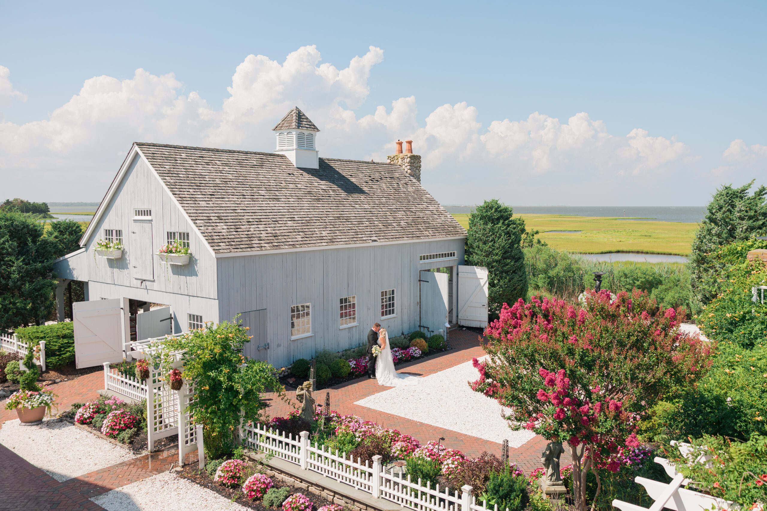 Bride and groom at Bonnet Island Estate sharing a kiss in the courtyard on the New Jersey coast
